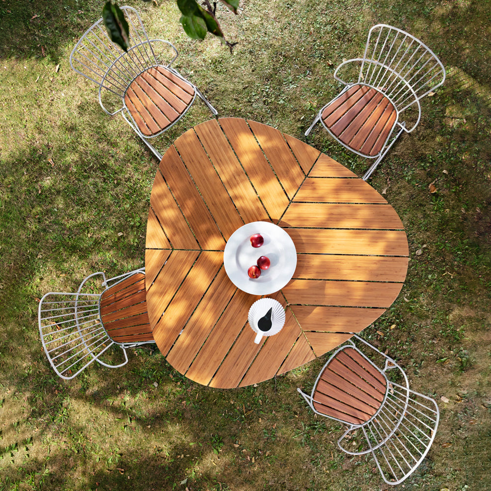 Wooden outdoor table with chairs on a grassy area
