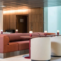 Modern seating in warm rust and cream tones, featuring sleek red accents and smooth, minimalist designs.