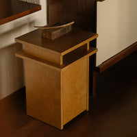 Modern wooden side table in warm honey tones with a sleek, minimalist design and smooth finish.