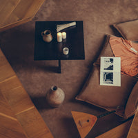 Neutral tones in a cozy living space with brown, beige, and soft peach patterns. Decorative items enhance the warm ambiance.