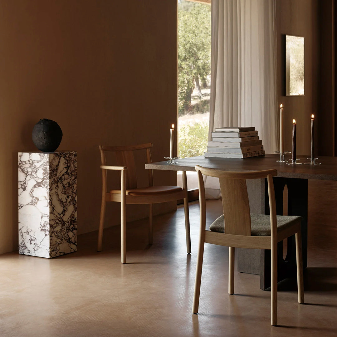 Elegantly designed marble side table with black and white patterns, complementing a neutral-toned interior.