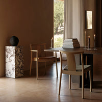 Elegantly designed marble side table with black and white patterns, complementing a neutral-toned interior.