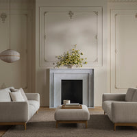 Light gray sofas with subtle textures, complemented by a soft beige rug and elegant cream wall accents.