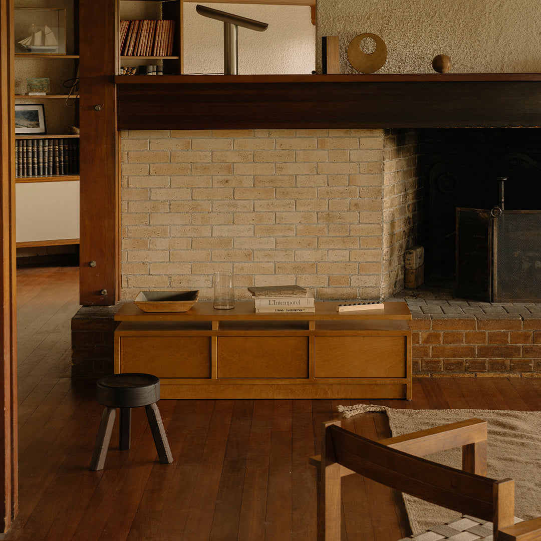 Natural wood tones with a textured brick wall and soft beige patterns, creating a warm, inviting interior atmosphere.