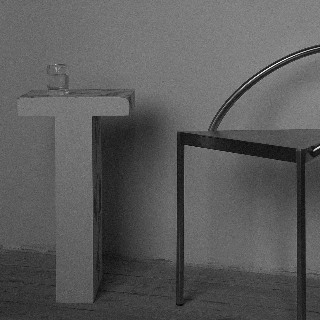 Minimalist black and white furniture set with sleek geometric shapes and smooth metallic finishes.