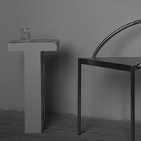 Minimalist black and white furniture set with sleek geometric shapes and smooth metallic finishes.
