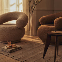 "Cozy beige and brown lounge chairs with soft, curved shapes in a warm-toned living room setting."