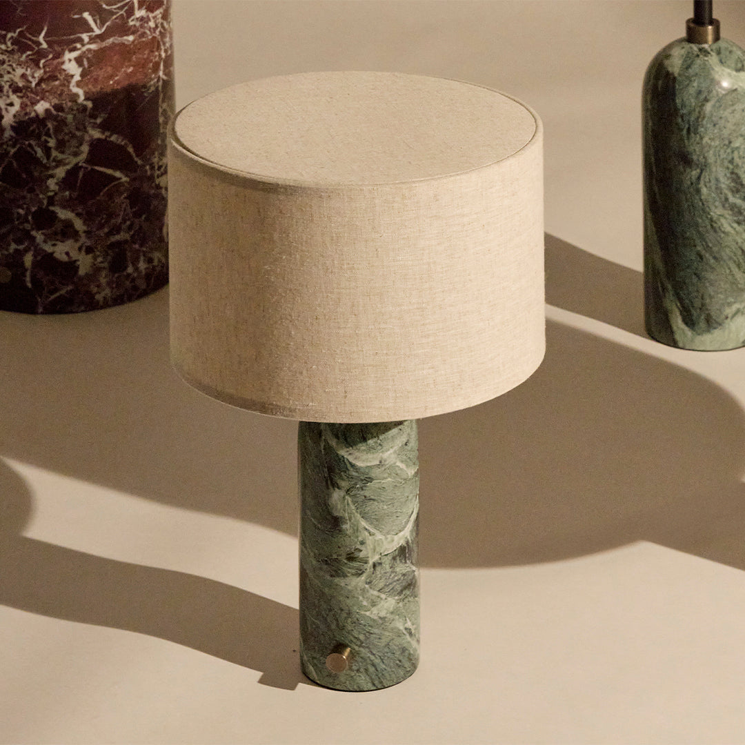 Green marble lamp base with a beige fabric shade, showcasing elegant patterns and a contemporary design.