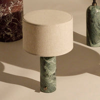 Green marble lamp base with a beige fabric shade, showcasing elegant patterns and a contemporary design.