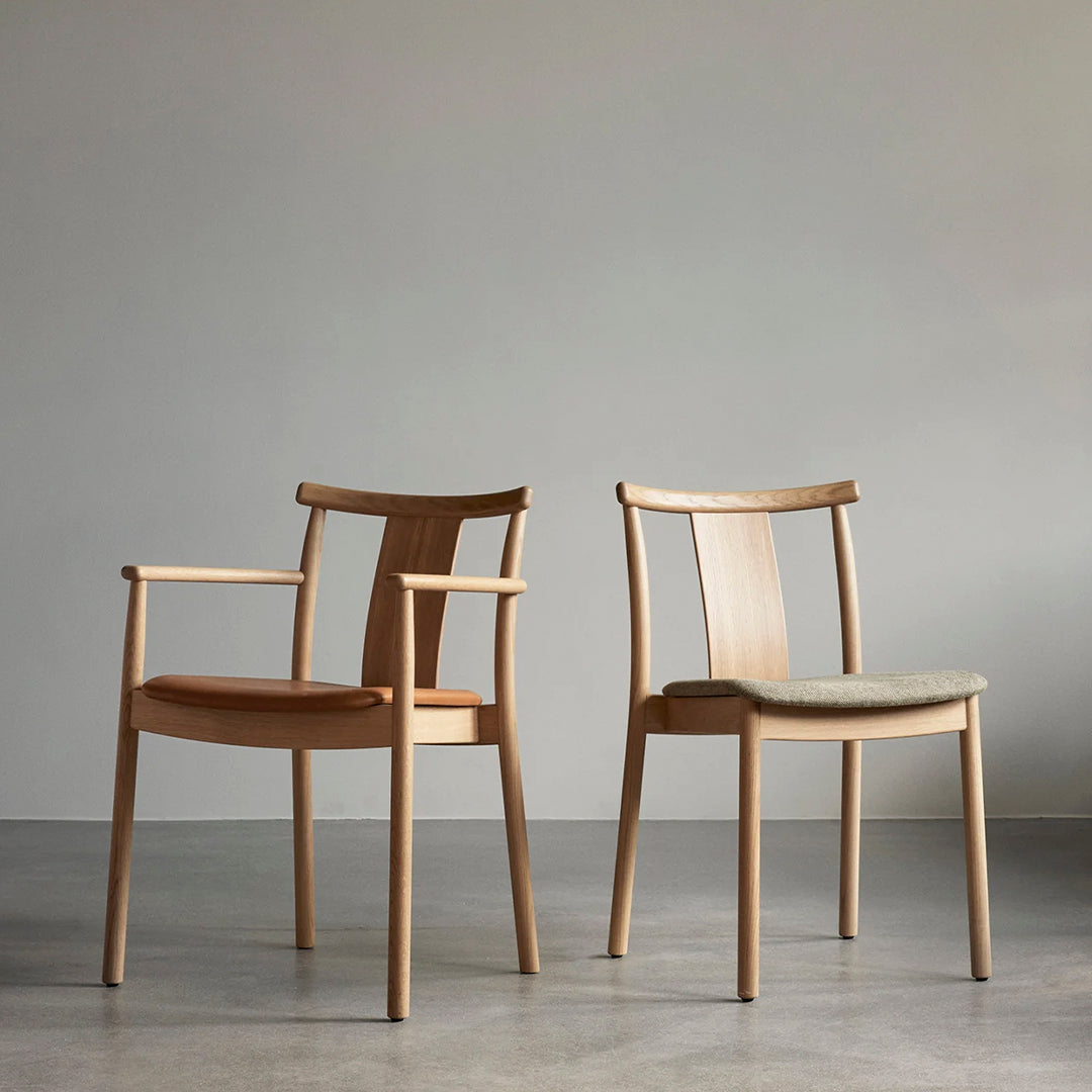 Light wood dining chairs featuring a minimalist design and soft beige cushions, perfect for modern interiors.