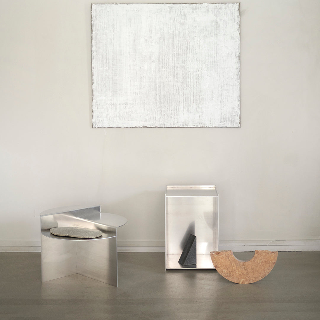 Sleek metallic finishes with geometric patterns, featuring silver, black, and warm beige accents. Modern minimalist decor.