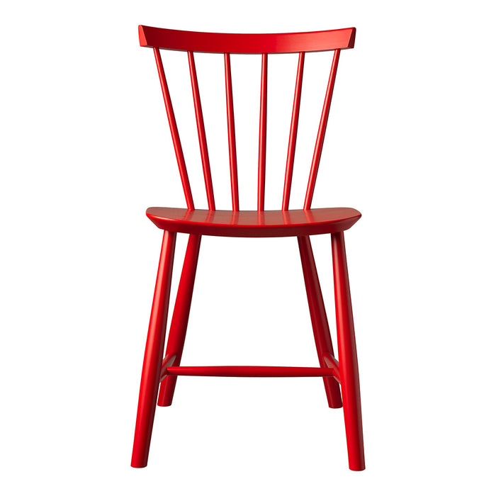Bright red wooden chair with a classic spindle design and smooth finish, perfect for modern decor.