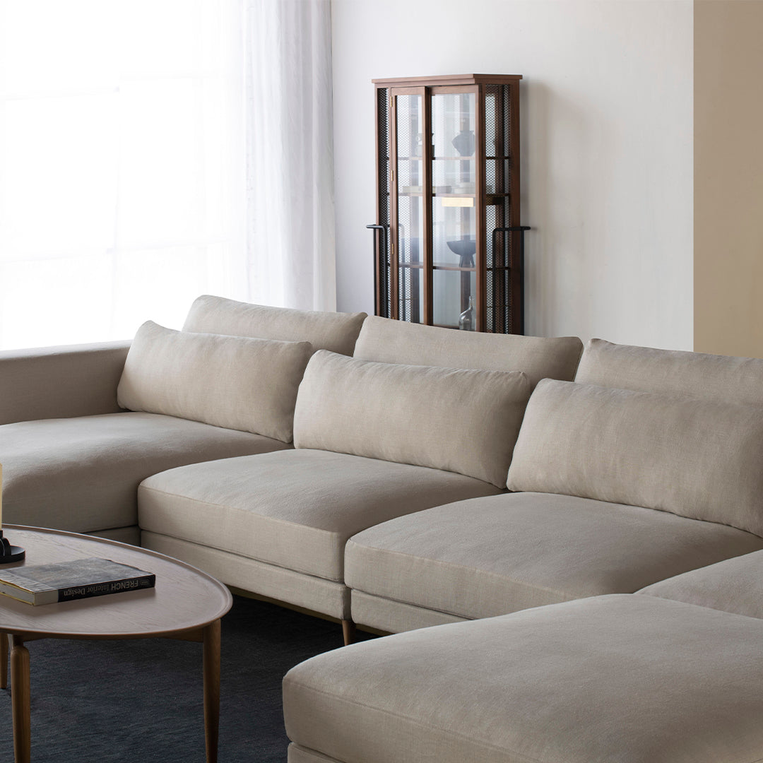 Beige sectional sofa with a smooth, clean texture and modern design. Ideal for contemporary living spaces.