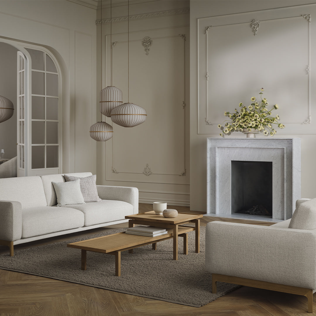 Neutral-toned living room with cream sofas, light wood accents, and subtle textures, topped with minimalist decor.