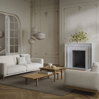 Modern living room featuring neutral tones, soft textures, and natural wood accents in a stylish, minimalist design.