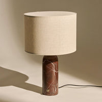 Beige linen lampshade on a brown marble base with white veining, creating a modern, sophisticated look.