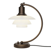 Bronze desk lamp with a sleek, curved design and layered white glass shades. Modern, minimalist style.