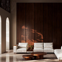 Modern white sofa set with minimalistic design, complemented by rich brown wood accents and soft natural lighting.