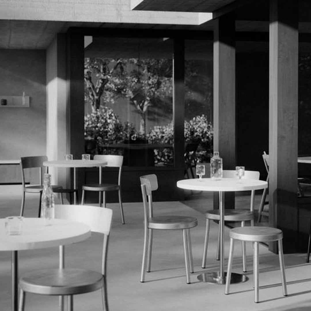 Modern black and white café scene featuring simple furniture and elegant patterns in natural light.