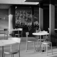 Modern black and white café scene featuring simple furniture and elegant patterns in natural light.