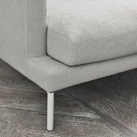 Grey textured upholstery with a smooth finish and sleek white legs on a modern couch.