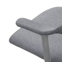 Gray upholstered chair with a subtle herringbone pattern and sleek metal armrest. Perfect for modern decor.