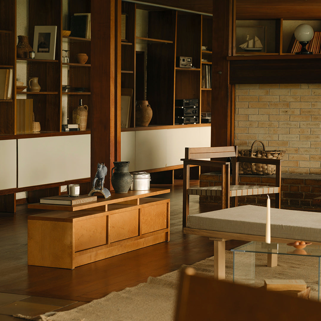 Modern wooden furniture in warm tones, featuring a blend of light and dark finishes with subtle textures and clean lines.
