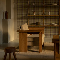 Natural wood tones with a warm beige fabric, featuring a minimalist design and soft textures in a cozy setting.