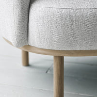 Light gray textured fabric with natural wood legs, showcasing a modern minimalist design.
