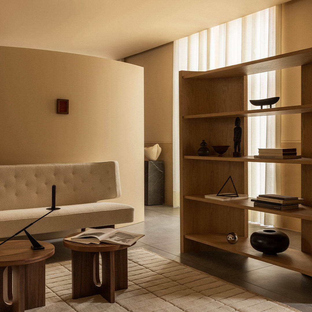 Beige and neutral-toned living room featuring textured walls, minimalist furniture, and geometric decor patterns.