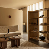 Beige and neutral-toned living room featuring textured walls, minimalist furniture, and geometric decor patterns.