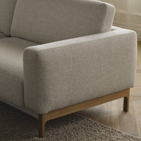 Light gray textured fabric sofa with wooden legs, featuring a minimalist design and soft, neutral tones.