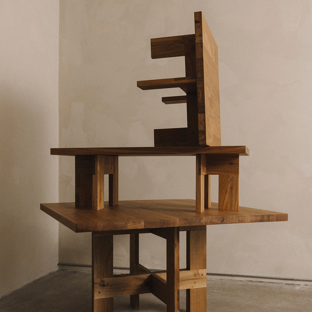 Geometric wooden furniture with a warm, natural finish and contrasting light and dark patterns.