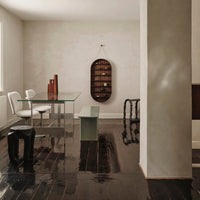 Modern interior featuring a mix of sleek black, white, and muted green tones with minimalist patterns and textures.