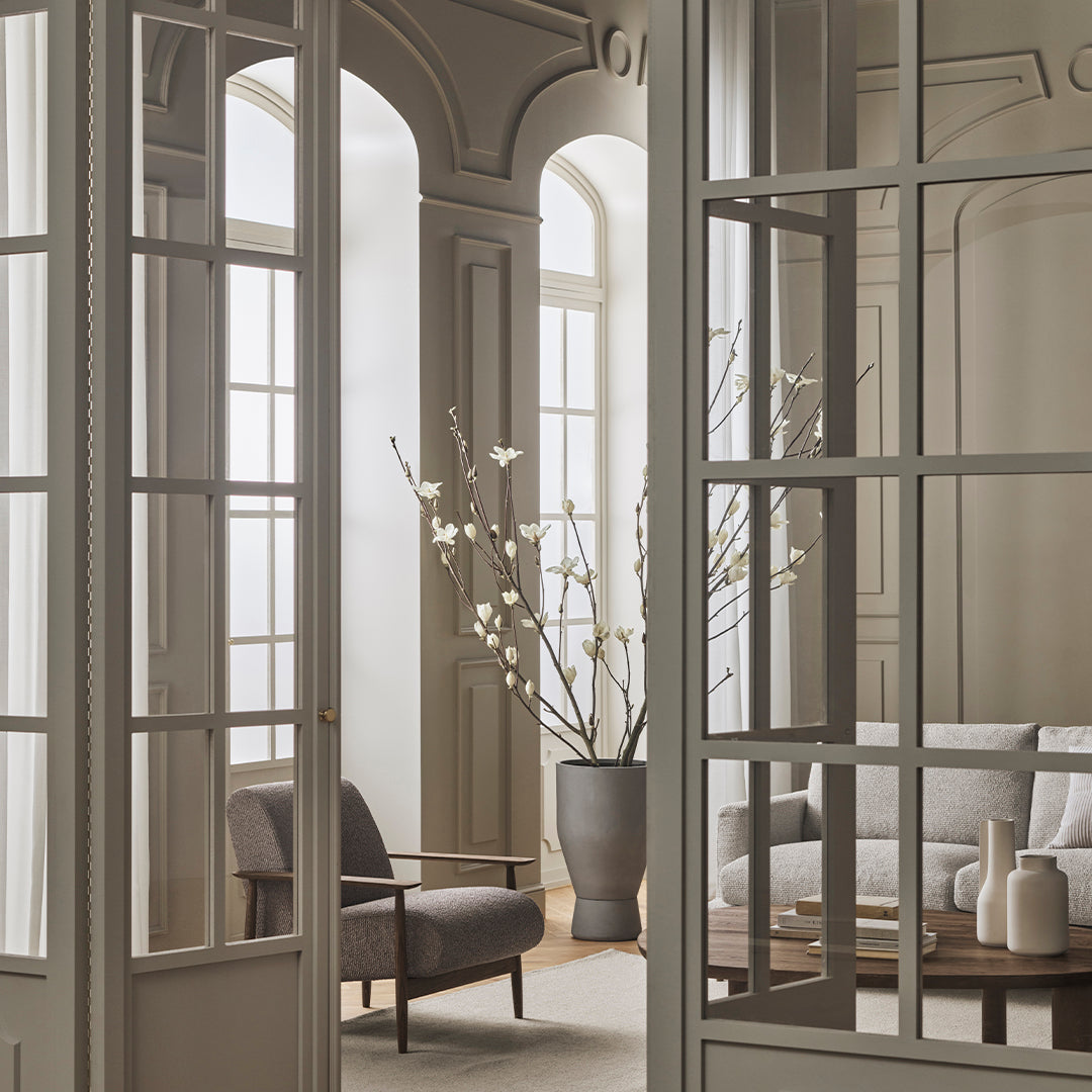 Elegant neutral tones with soft textures; minimalist design featuring light gray walls and natural wood accents.