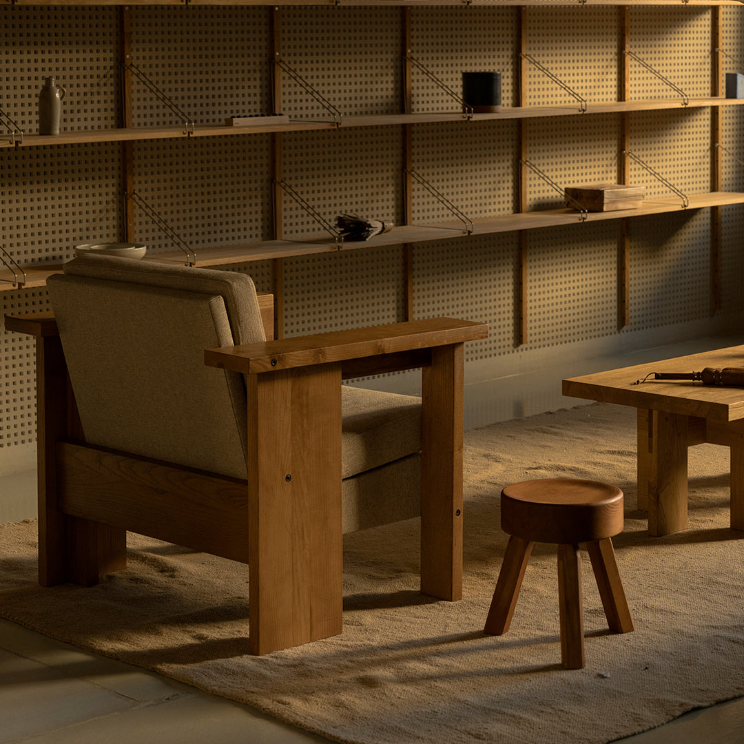 Wooden chair and table set in natural oak finish, featuring neutral fabric and warm earthy tones. Minimalist design.