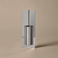 Sleek silver metal with a polished finish, set against a soft beige background. Modern, minimalist design.