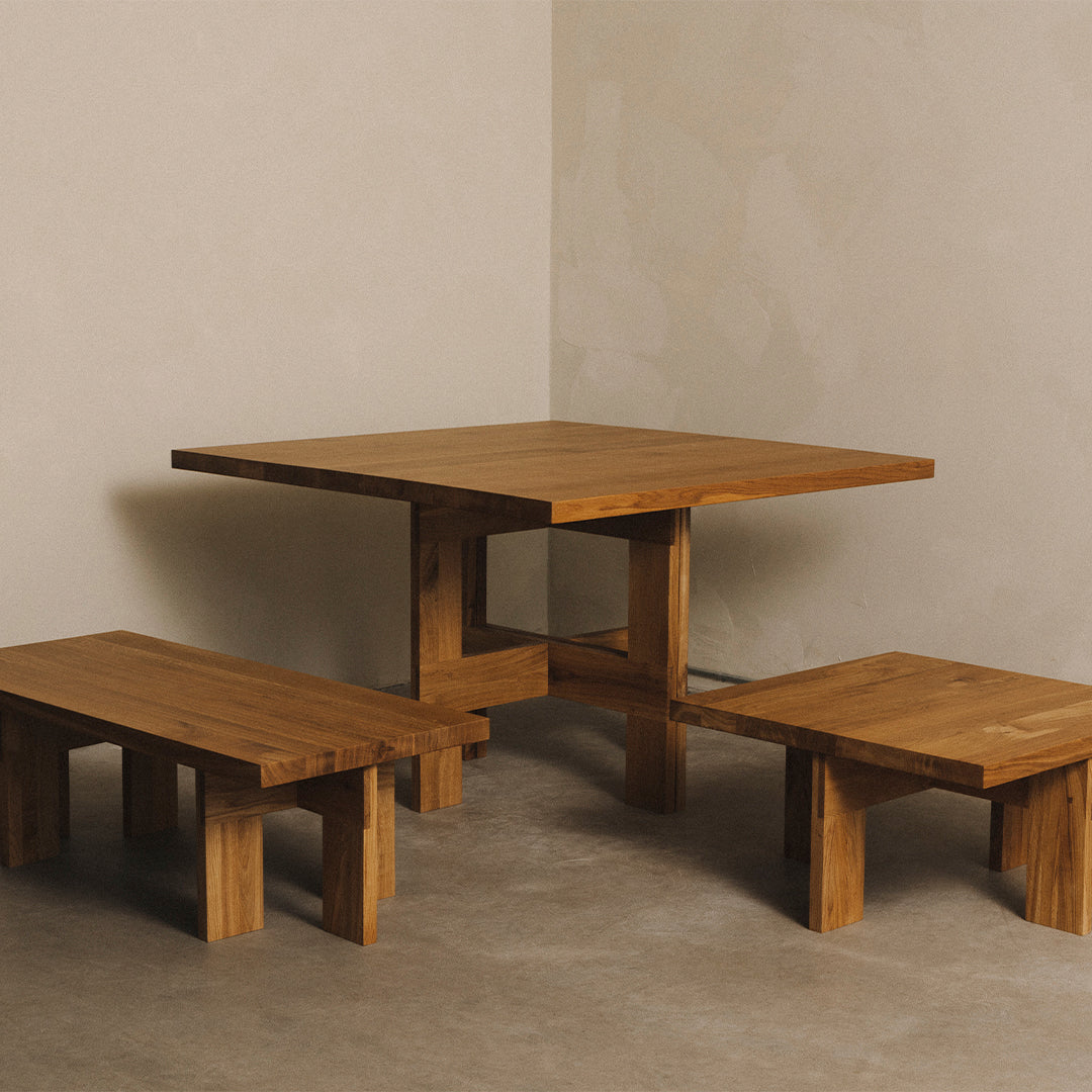 Wooden table and benches featuring a natural finish, showcasing rich brown tones and simple geometric patterns.