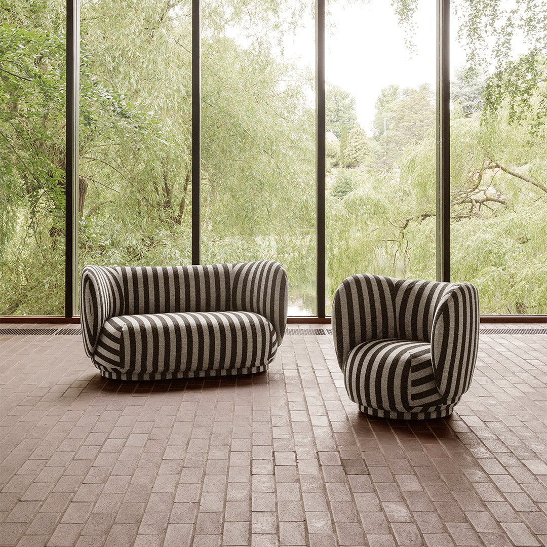 Black and white striped sofa set with soft, rounded shapes against a natural backdrop.