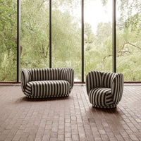 Black and white striped sofa and chair set, featuring bold patterns in a contemporary interior setting.