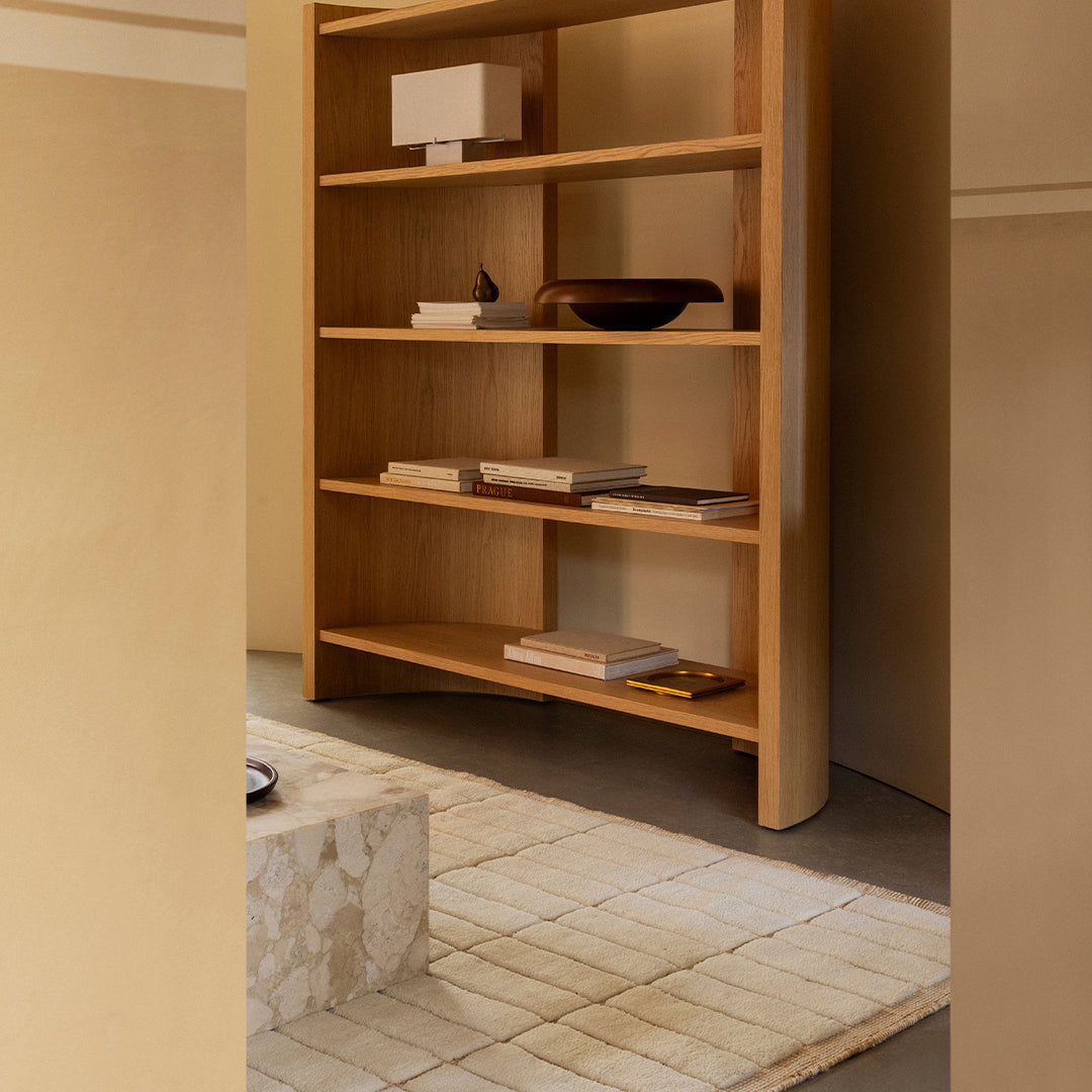 Natural wood shelving unit with a minimalist design, accented by neutral tones and a subtle geometric pattern.