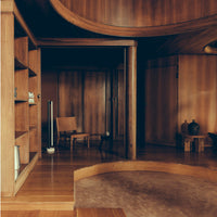 Cozy wooden interiors featuring warm tones, curved lines, and natural textures for a serene atmosphere.
