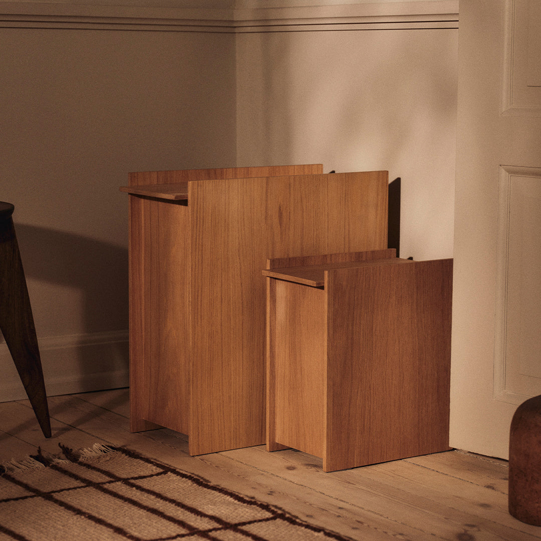 Natural wood finish with warm tones and minimalist design in two box-shaped side tables.