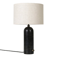 Black marble lamp base with a cream linen shade, featuring a sleek, modern design and minimalist aesthetic.