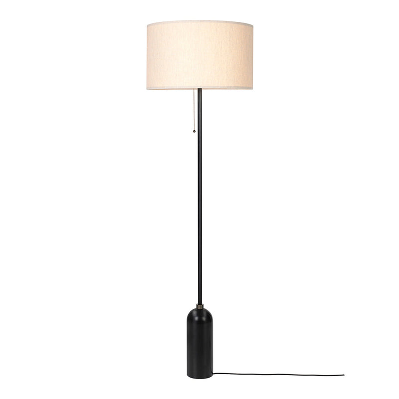 Black floor lamp with beige fabric shade, featuring a minimalist design and sleek lines. Ideal for modern decor.