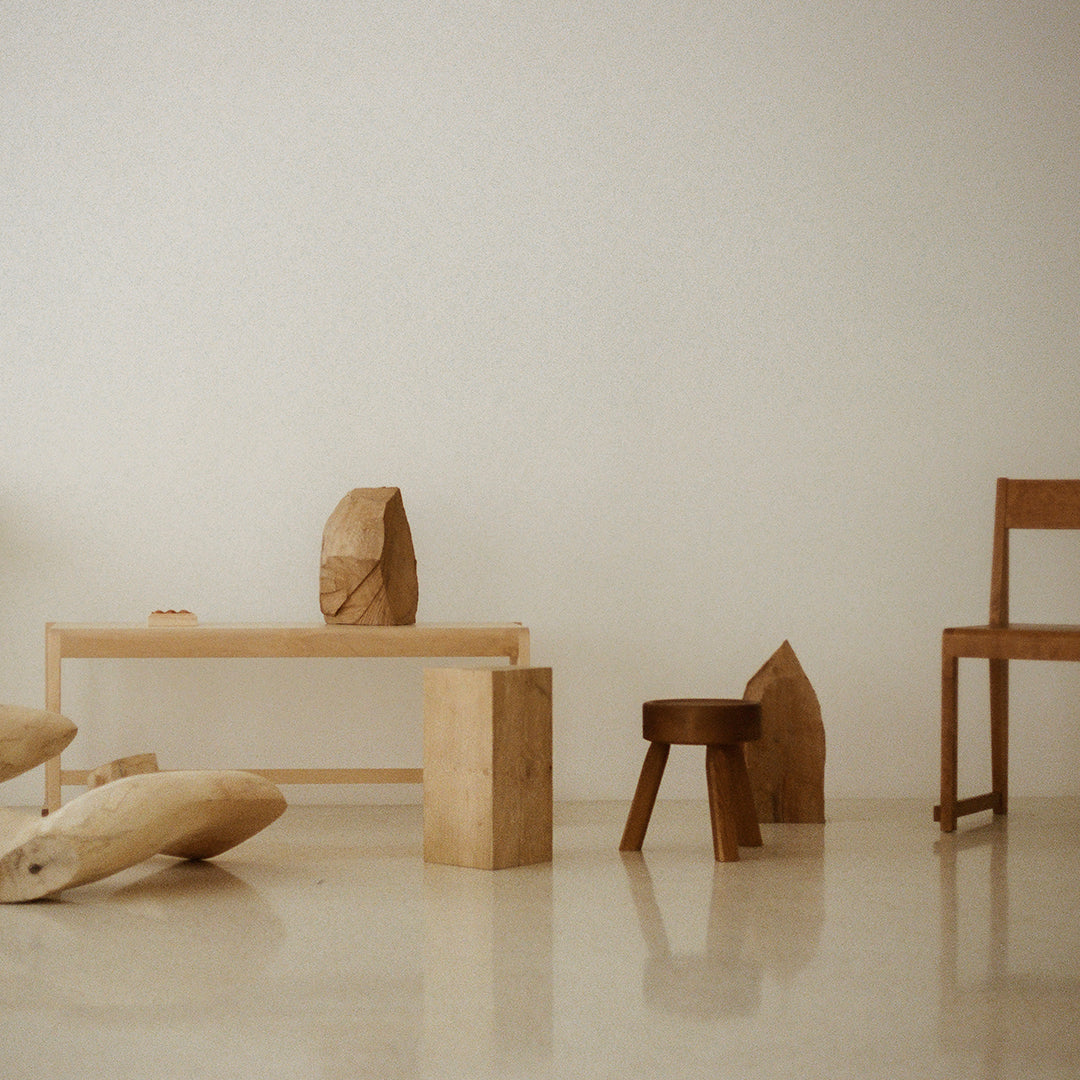 Warm wooden tones and natural textures blend with a minimalistic design in a light, airy space.