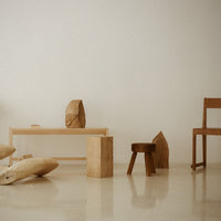Warm wooden tones and natural textures blend with a minimalistic design in a light, airy space.
