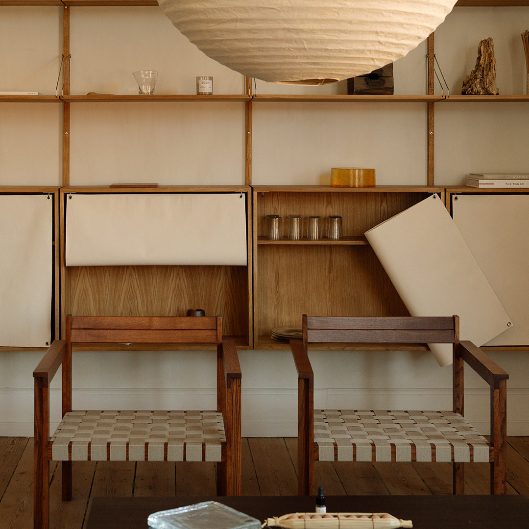 "Neutral tones with textured beige cushions and natural wood accents in a modern interior setting."