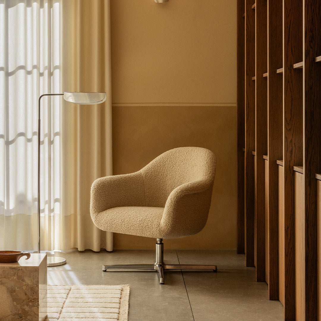 Beige patterned chair with a smooth texture, set against warm beige walls and soft, natural lighting.