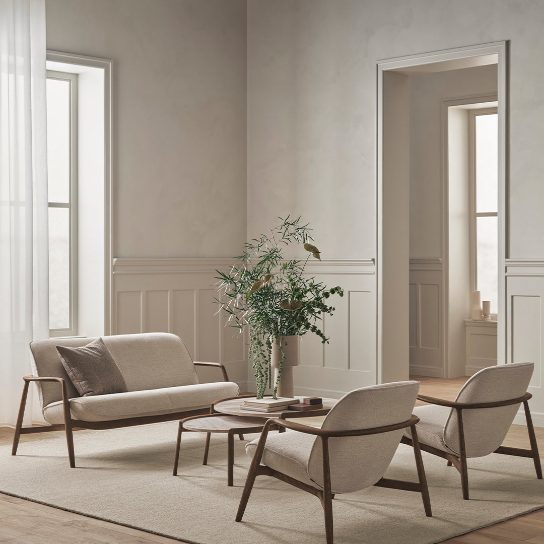 Beige upholstery with soft, taupe accents and natural wood tones, set in a minimalistic indoor space.